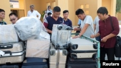 FILE - Chinese workers are seen after arriving at Gwadar Airport, in Gwadar, Pakistan Oct. 3, 2017.