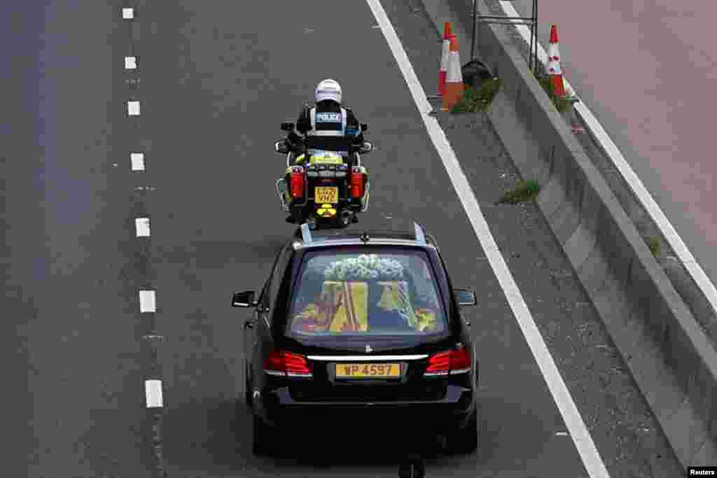 The hearse carrying the coffin of Britain's Queen Elizabeth travels along the A90 road in Dundee, Scotland, Sept. 11, 2022.