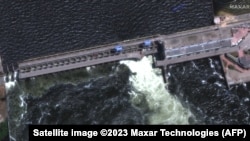 This handout satellite image courtesy of Maxar technologies shows a closer view of a destroyed roadway and section of the Nova Khakovka dam in south Ukraine, June 5, 2023. 