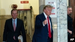 FILE - Former President Donald Trump gives a thumbs up as he returns to the courtroom from a break at New York Supreme Court, in New York City, Dec. 7, 2023.