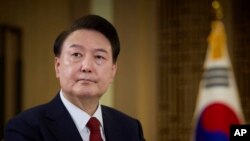 In this photo provided Feb. 7, 2024, by the South Korea Presidential Office, South Korean President Yoon Suk Yeol speaks during a pre-recorded interview with KBS television at the presidential office in Seoul, South Korea, Feb. 4, 2024.