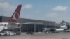 FILE - Airplanes are parked at Aden Adde International Airport in Mogadishu, Somalia, on Feb. 13, 2022. A passenger plane crash-landed at the airport on July 11, 2023.