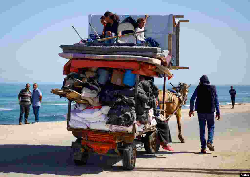 Palestinians flee in an animal-drawn cart after Israeli forces launched a ground and air operation in the eastern part of the southern Gaza city, in the southern Gaza Strip.