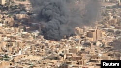 A screen grab shows black smoke and fire at Omdurman market in Omdurman, Sudan, May 15, 2023. Omdurman neighbors Sudan's capital, Khartoum. (Handout via Reuters)