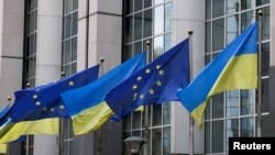 Flags of Ukraine fly in front of the EU Parliament building on the first anniversary of the Russian invasion, in Brussels, Belgium, Feb. 24, 2023. 