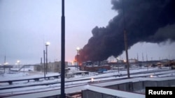 Smoke billows after Ukrainian drones strike a refinery, amid Russia's invasion of Ukraine, in Ryazan, Russia, in this screen grab from video obtained by Reuters, March 13, 2024.