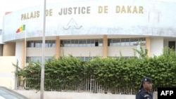 FILE - A Senegalese police officer is seen in front of a courthouse in Dakar on Sept. 21, 2022. 