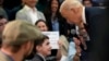 U.S. President Joe Biden talks to Harry Abramson during a visit to the Biden campaign office in Milwaukee, Wisconsin, March 13, 2024. 