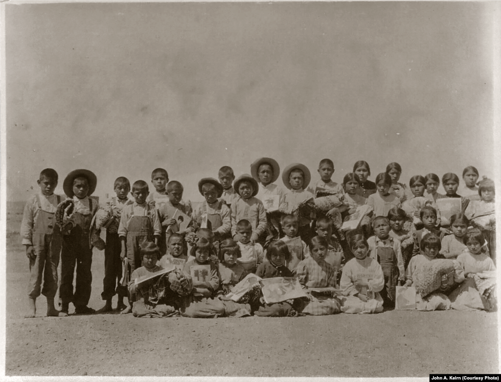 In this undated photo taken by John A. Keirn, students pose with rugs and popular American magazines. Courtesy: Beinecke Rare Book and Manuscript Library, Yale University.