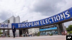People walk outside the European Parliament in Brussels, May 23, 2024. Police searched the Belgian and French offices, as well as the residence, of a European Parliament employee on May 29, as part of a probe into a suspected Russian interference campaign.