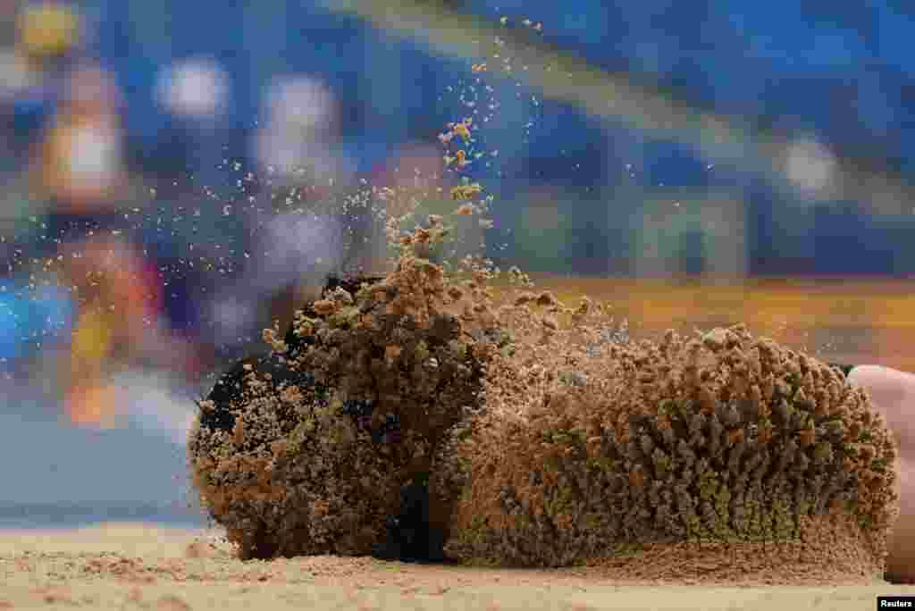 Turkey's Ecem Calagan lands in the sand after sustaining an injury during the Women's Long Jump during the European Games in Chorzow, Poland, June 25, 2023.