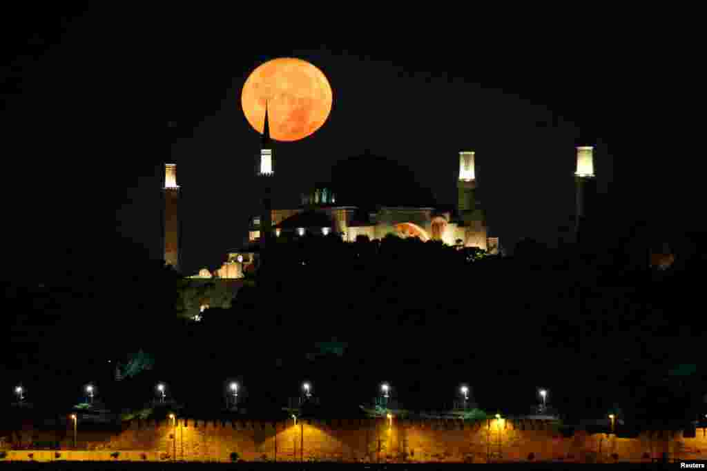 The moon is pictured over the Ayasofya-i Kebir Camii, or Hagia Sophia Grand Mosque, in Istanbul, Turkey.