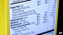 FILE - A nutrition facts label is seen on the side of a cereal box in Washington, D.C, Jan. 23, 2014.