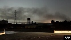 Smoke billows in Khartoum, Sudan, amid fighting between the forces of two rival generals, on May 11, 2023. Almost a month of heavy fighting has turned Khartoum into a war zone.
