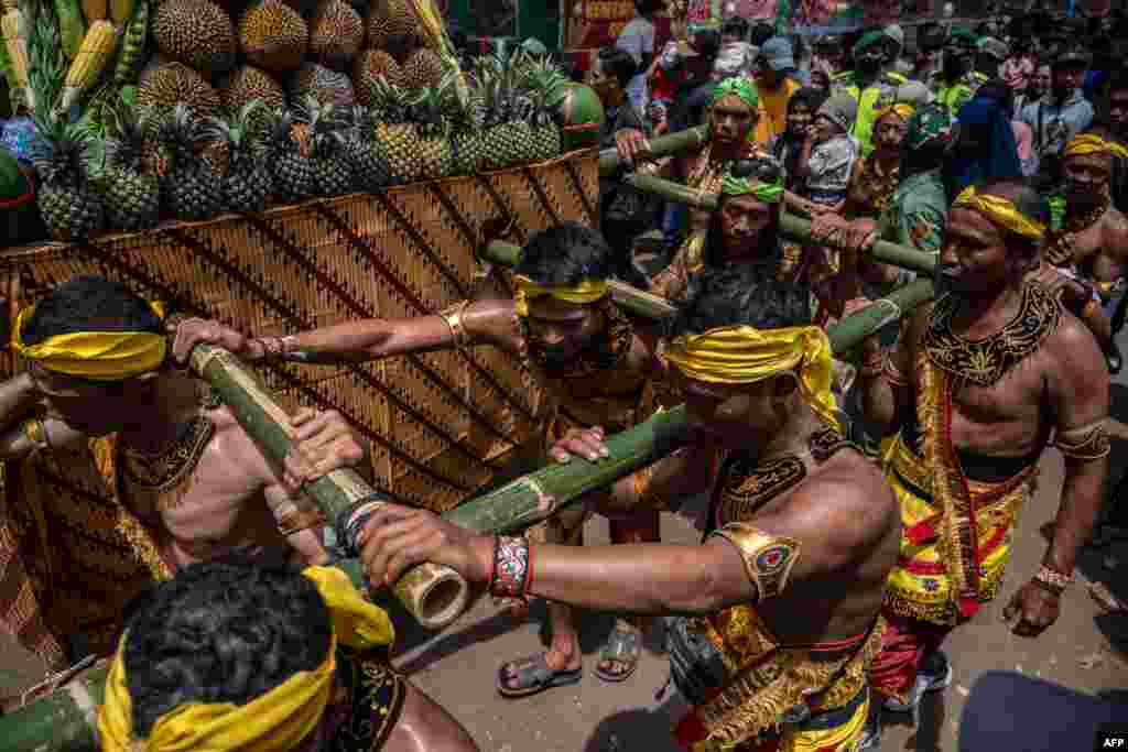 Participants parade with heaps of durians during the 'Kenduren' festival in Jombang, East Java, Indonesia.