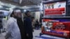 Men watch television screens as they await the appearance of Pakistan's jailed former Prime Minister Imran Khan, expected to be streamed live during a video proceeding of the Supreme Court of Pakistan, at a market in Peshawar, Pakistan May 16, 2024.