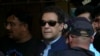 FILE - Pakistan's former Prime Minister Imran Khan is escorted by security officials as he arrives at court in Islamabad, May 12, 2023.