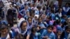 Students leave after attending school as authorities announced reduced classroom hours due to soaring temperatures, in Lahore, Pakistan, May 21, 2024.