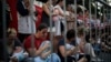 Relatives and supporters of Israeli hostages held by Hamas in the Gaza Strip hold baby dolls during a performance marking nine months since the start of the war and calling for their return, in Tel Aviv, Israel, July 7, 2024.