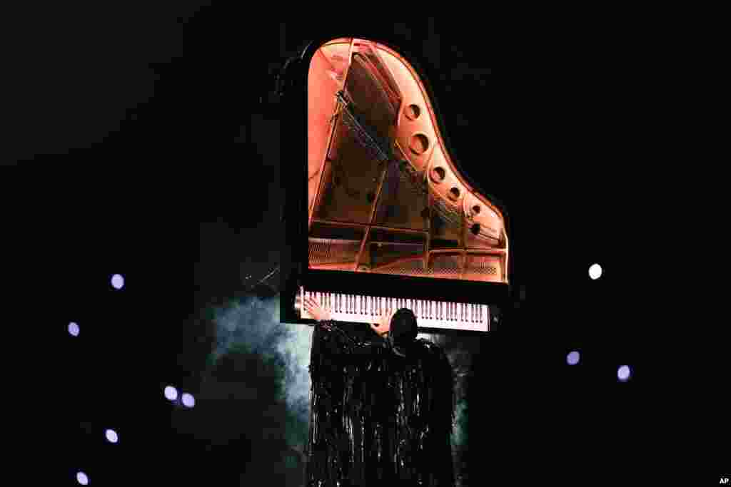 Artist Alain Roche plays a piano during the 2024 Summer Olympics closing ceremony at the Stade de France, Aug. 11, 2024, in Saint-Denis, France.