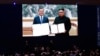 FILE - Members of the media watch a screen showing South Korea's then-President Moon Jae-in and North Korean leader Kim Jong Un hold documents after signing in Pyongyang, North Korea, at a press center for the inter-Korean summit in Seoul, South Korea, on Sept. 19, 2018.