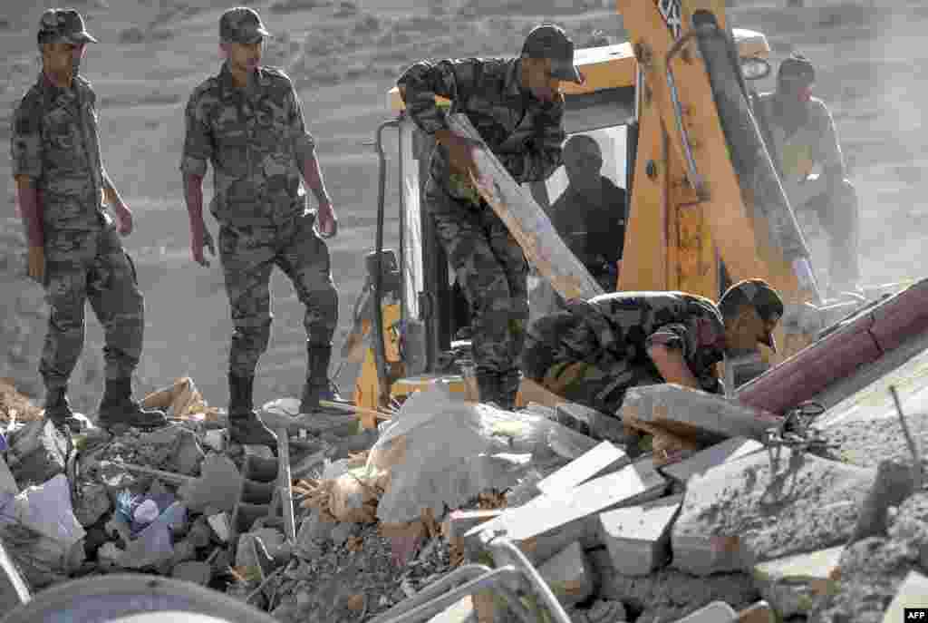 Moroccan Royal Armed Forces search through the rubble of houses after an earthquake in the mountain village of Tafeghaghte, southwest of the city of Marrakesh, Morocco, on Sept. 9, 2023.