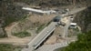 FILE - A bridge and a checkpoint are seen on a road towards the separatist region of Nagorno-Karabakh in Armenia, July 28, 2023. 