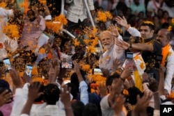 FILE - Indian Prime Minister Narendra Modi greets supporters as he arrives for an election campaign rally of his Bharatiya Janata Party (BJP) in Hyderabad, India, Tuesday, Nov. 7, 2023. (AP Photo/Mahesh Kumar A. File)