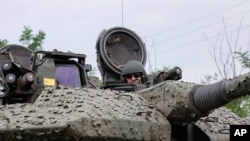 A Ukrainian soldier on a Swedish CV90 infantry fighting vehicle at his positions near Bakhmut, Donetsk region, Ukraine, June 25, 2023.