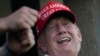 Former President Donald Trump laughs while looking over the 18th hole during the final round of the Bedminster Invitational LIV Golf tournament in Bedminster, NJ, Aug. 13, 2023. 