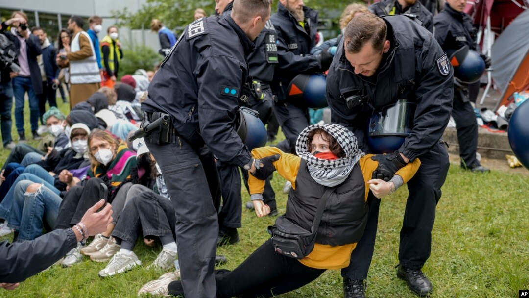 Police remove a protester from the 'Freie Universität Berlin' in Berlin, Germany, Tuesday, May 7, 2024. Pro-Palestinian activists occupied a courtyard of the Free University in Berlin on Tuesday. (AP Photo/Markus Schreiber)