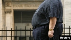 A man walks past the New York Stock Exchange after the close of trading hours in New York City on August 17, 2009. (REUTERS/Lucas Jackson)