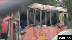 A damaged commercial bus is shown after several people were killed and dozens injured after it overturned on Interstate 20 on Aug. 31, 2024, in Warren County, Mississippi, according to the Mississippi Highway Patrol. (WAPT via AP)