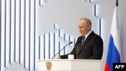 In this pool photograph distributed by Russian state agency Sputnik, Russia's President Vladimir Putin delivers his annual state of the nation address at the Gostiny Dvor conference center in Moscow, Feb. 29, 2024. (Photo by Dmitry Astakhov / Pool / AFP)