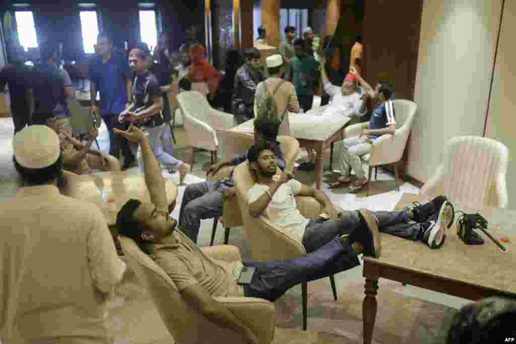 Anti-government protesters gather inside Prime Minister Sheikh Hasina's palace in Dhaka, Aug. 5, 2024.