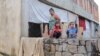 Familias de bajos recursos esperan por ayuda en medio del temor a más lluvias e inundaciones en Maracay, Venezuela, el 18 de octubre de 2022.