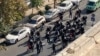 FILE - This frame grab from video taken by an individual not employed by the Associated Press and obtained by the AP outside Iran shows Iranian police dispersing a protest in Tehran, Iran, Oct. 26, 2022. Lawyers providing legal aid to protesters reportedly have been arrested.