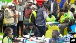 The Electoral Commission (IEBC) Chairman, Wafula Chebukati, middle in red shirt, and IEBC commissioners at the National Tallying Centre in Bomas of Kenya, Nairobi, Kenya, Aug. 14, 2022.
