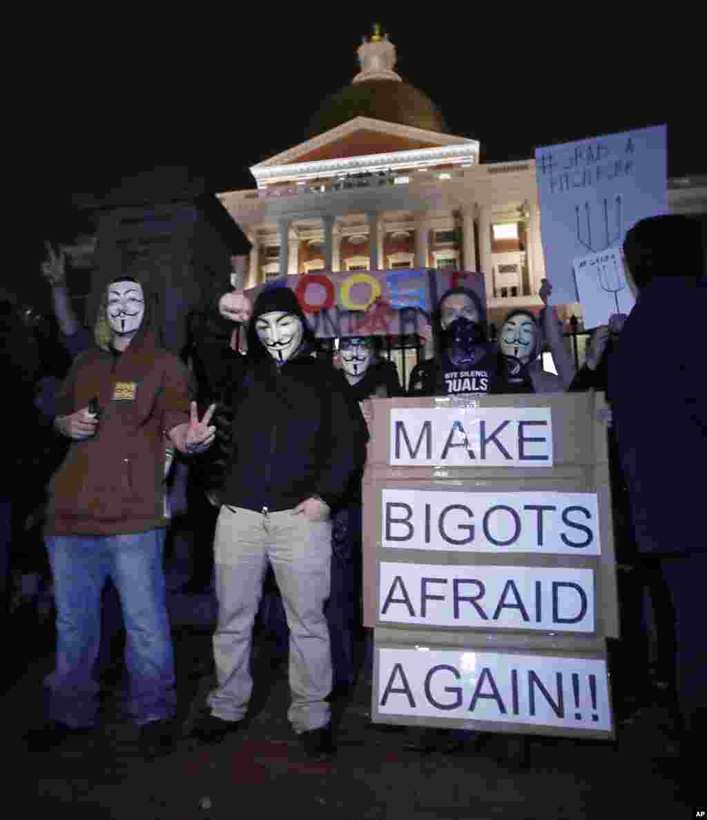 Protesters stand on the Mass. Statehouse steps in opposition of Donald Trump's presidential election victory in Boston, Nov. 9, 2016.