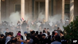 Pasukan keamanan Irak menembakkan gas air mata ke pengikut ulama Syiah Muqtada al-Sadr di dalam Istana pemerintah, Baghdad, Irak, 29 Agustus 2022. (Foto: AP)