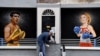 Seniman Ciaran Gallagher menyelesaikan mural buatannya yang menampilkan kandidat pemimpin Partai Konservatif Inggris Rishi Sunak dan Liz Truss, pada 17 Agustus 2022. Mural tersebut dibuat di pusat Kota Belfast, Irlandia Utara. (Foto: Reuters/Clodagh Kilcoyne)