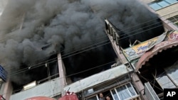 Palestinians remove debris from a building that was damaged in an Israeli strike, in Gaza City, Nov. 19, 2012. 