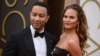 John Legend, left, and Christine Teigen arrive at the Oscars on March 2, 2014, at the Dolby Theatre in Los Angeles.