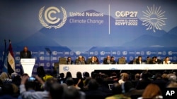 FILE - Sameh Shoukry, president of the COP27 climate summit, left, speaks during an opening session at the COP27 U.N. Climate Summit, Nov. 6, 2022, in Sharm el-Sheikh, Egypt.
