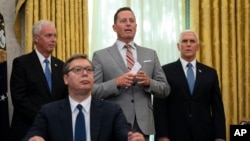 President Donald Trump’s special envoy on Serbia and Kosovo Richard Grenell speaks during a signing ceremony with Serbian President Aleksandar Vucic sitting at a desk in the Oval Office of the White House in Washington, Sept. 4, 2020.