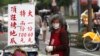 People wear face masks to protect against the spread of COVID-19 in Taipei, April 26, 2022.