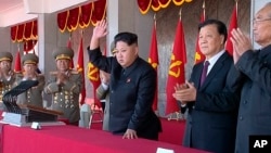 FILE - In an image made from video, North Korean leader Kim Jong Un, center, and Liu Yunshan, China's Communist Party's No. 5 leader, second right, waves during a ceremony to mark the 70th anniversary of the country's ruling party, in Pyongyang, Oct. 10, 