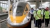 Pekerja dan pejabat memeriksa unit Comprehensive Inspection Train (CIT) yang baru diluncurkan di stasiun KA Cepat Jakarta-Bandung di Tegalluar, Jawa Barat, Kamis, 13 Oktober 2022. (AP/Dita Alangkara)