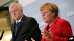  FILE - German Chancellor Angela Merkel (r) and the Governor of the German State of Bavaria, Horst Seehofer.