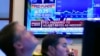 A television screen on the floor of the New York Stock Exchange, March 16, 2022, shows the rate decision of the Federal Reserve.